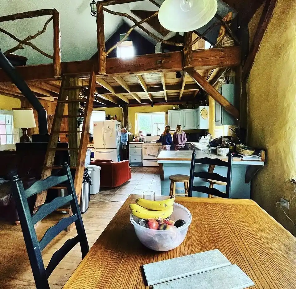 Interior of the straw bale cabin at the Brierpatch, loft and wood beams